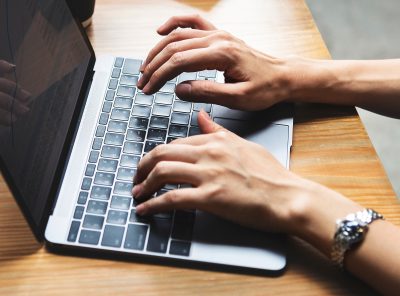 hands typing on keyboard